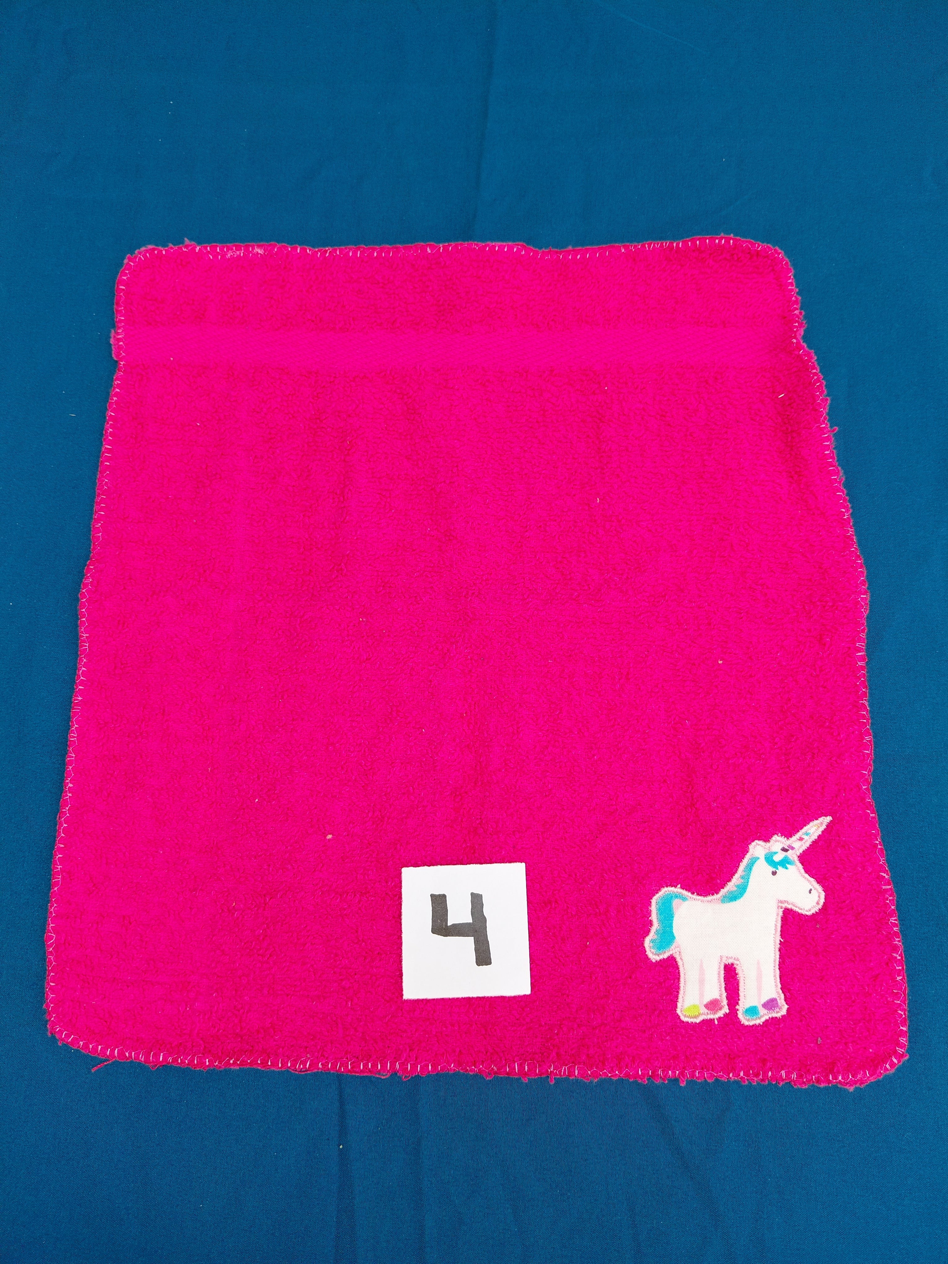Bright pink embellished washcloth with unicorn, reinforced hem
