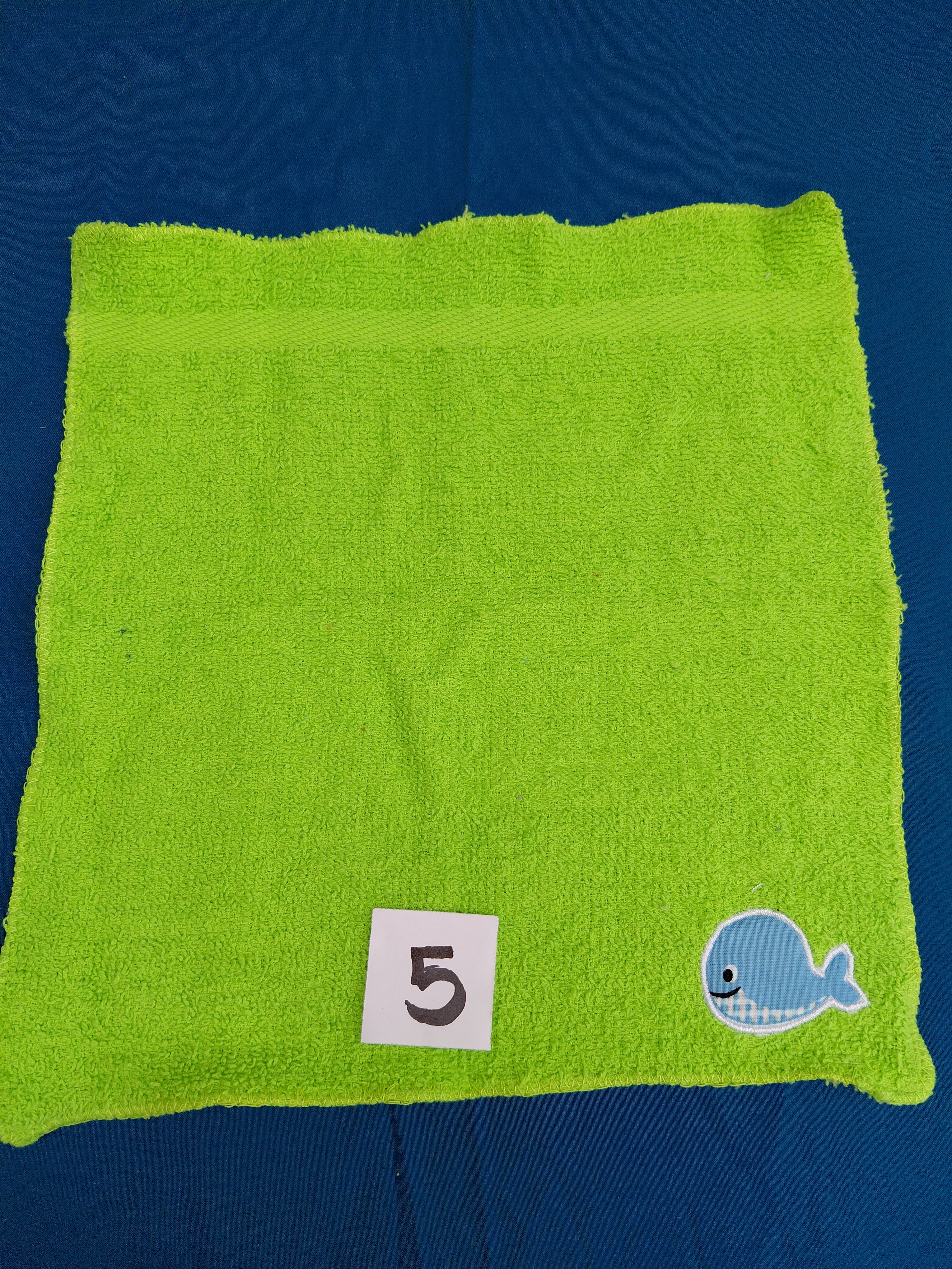 Bright lime green embellished washcloth with whale, reinforced hem