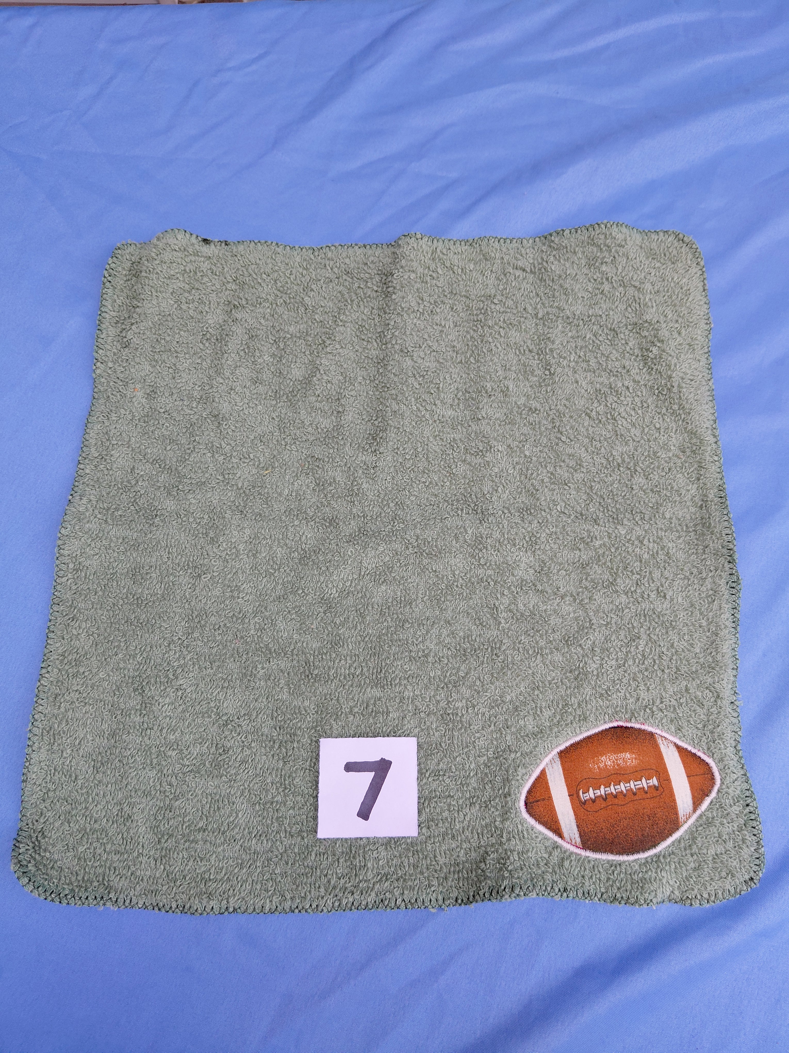 Sage green embellished washcloth with football, reinforced hem