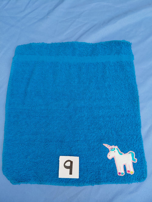 Bright aqua blue embellished washcloth with unicorn, reinforced hem