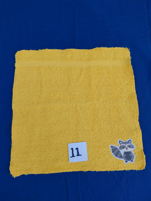 Bright deep gold embellished washcloth with raccoon, reinforced hem

