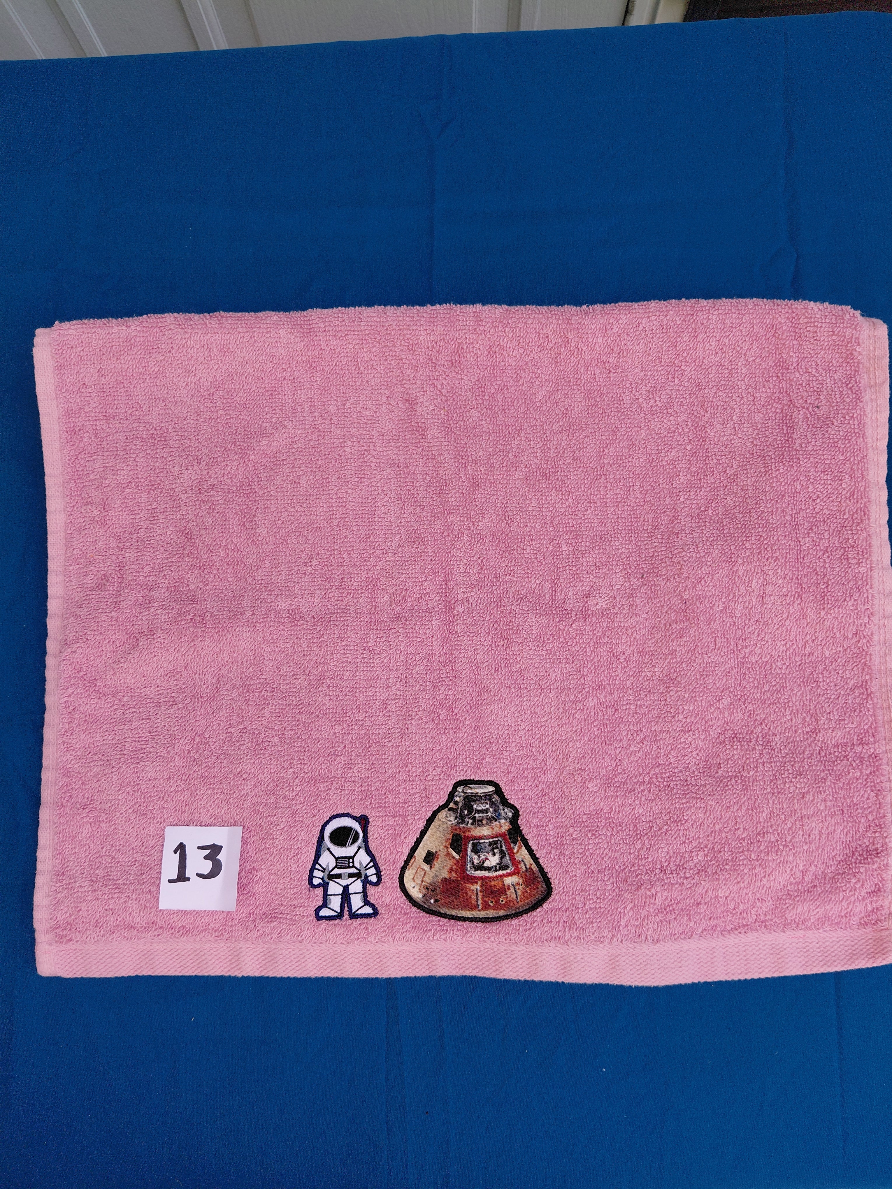 Rose pink embellished hand towel with astronaut and space shuttle, reinforced hem