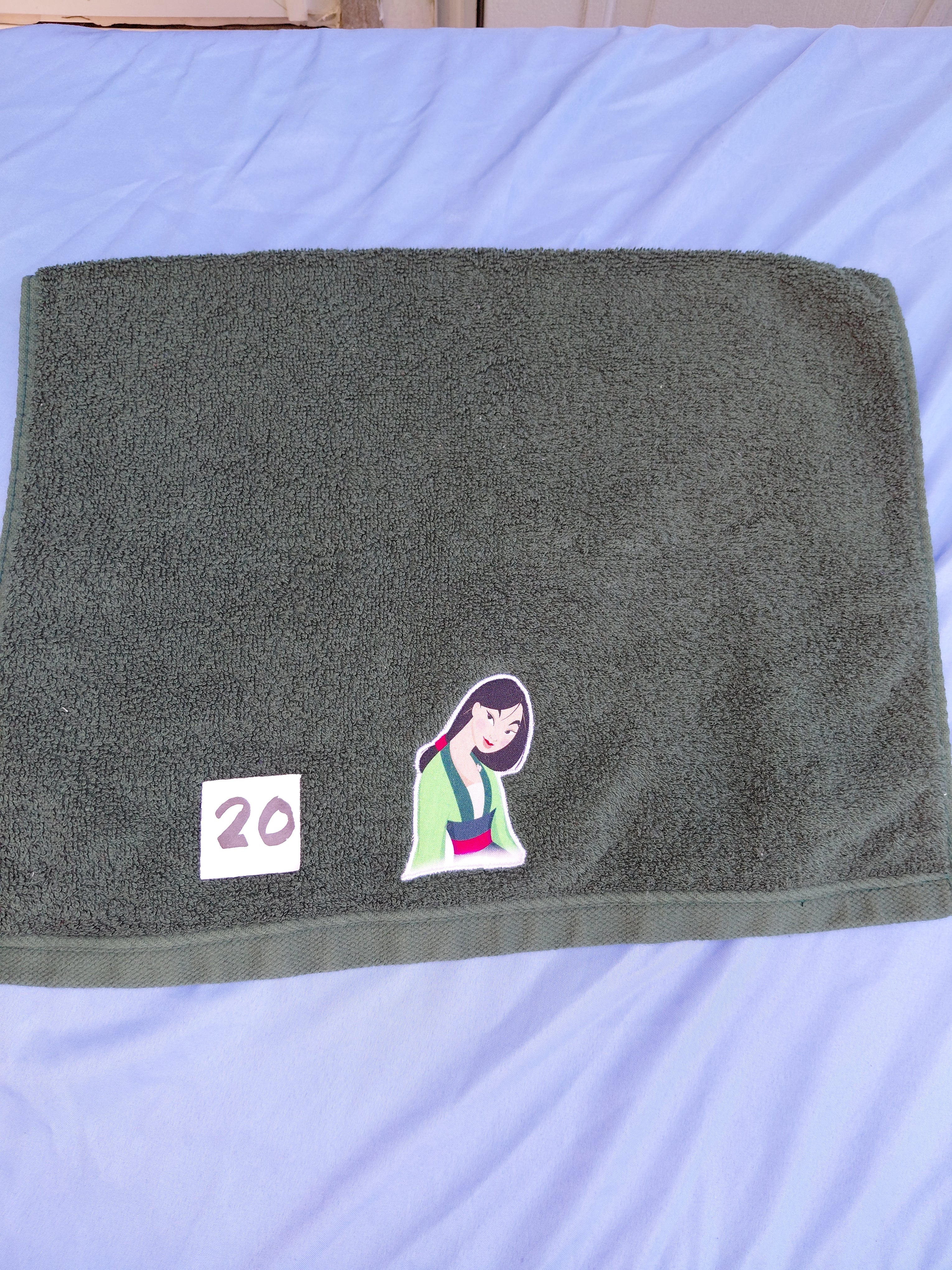 Dark forest green embellished hand towel with princess design, reinforced hem