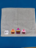 Stormy gray embellished hand towel with three cupcakes, reinforced hem

