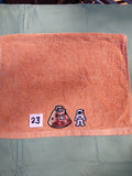 Burnt orange embellished hand towel with astronaut and space capsule, reinforced hem