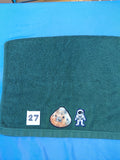 Dark forest green embellished hand towel with astronaut and space capsule, reinforced hem