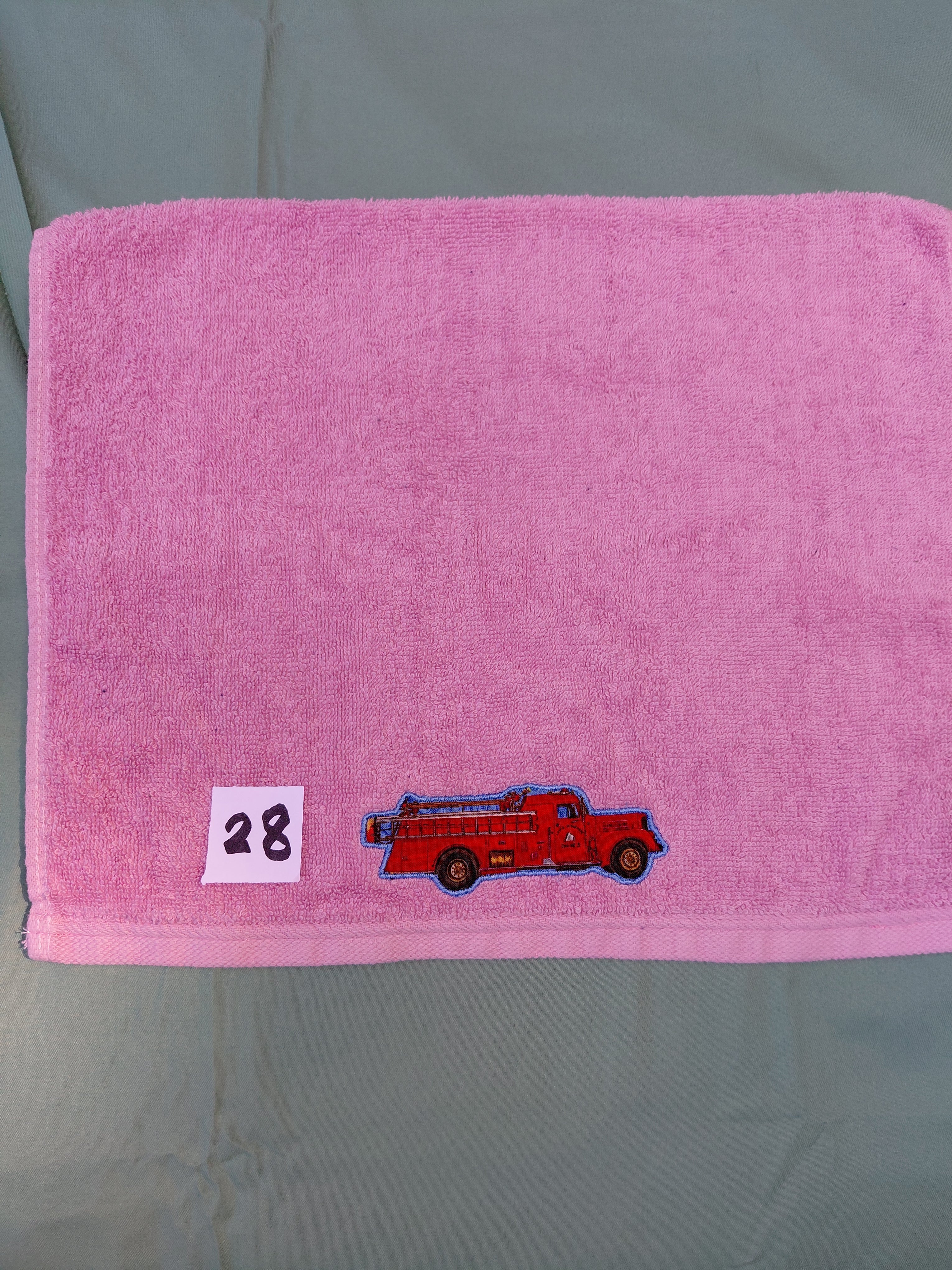 Rose pink embellished hand towel with fire engine, reinforced hem