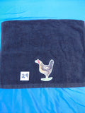 Black embellished hand towel with chicken holding a flower in its beak, reinforced hem