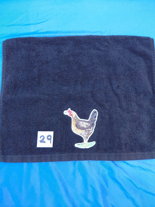 Black embellished hand towel with chicken holding a flower in its beak, reinforced hem