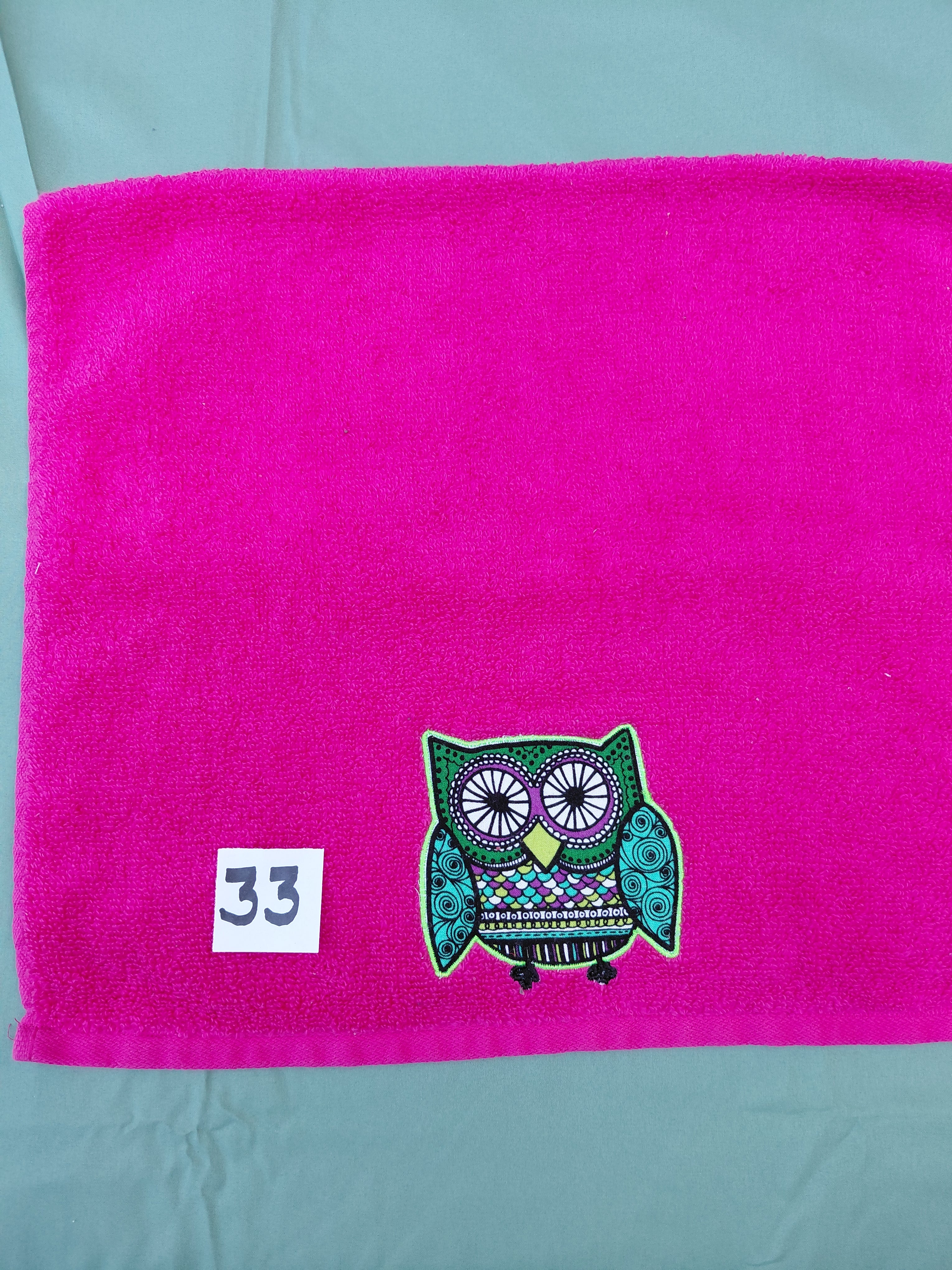 Magenta handcrafted embellished hand towel with lime green outlined owl appliqué, reinforced hem