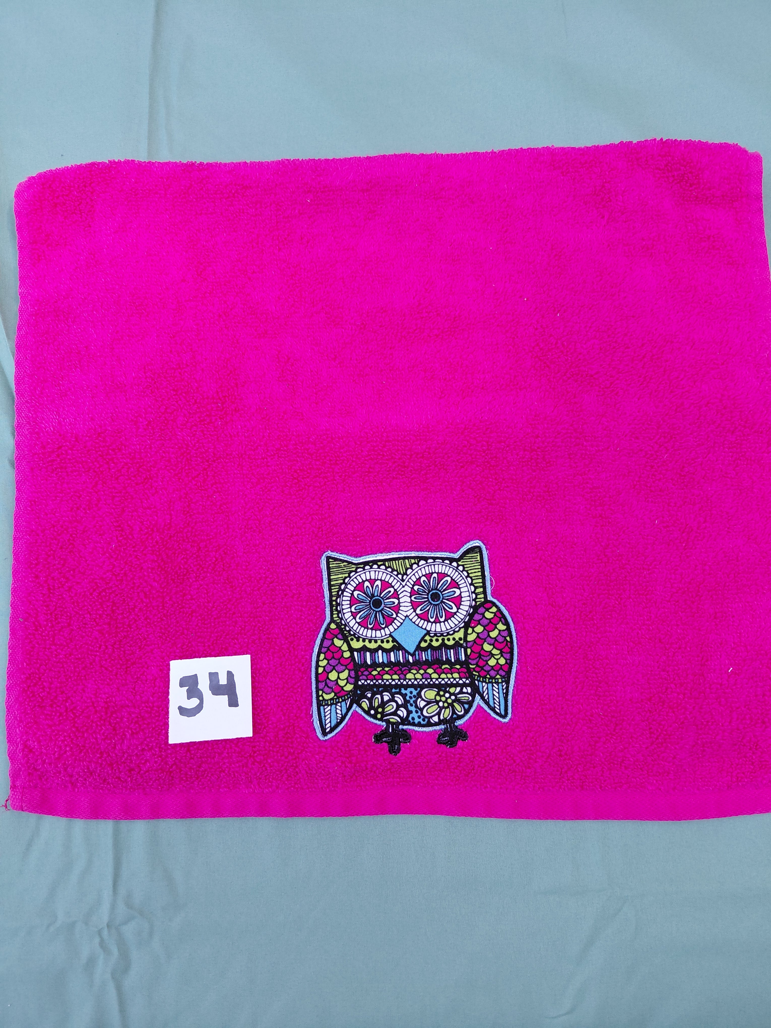 Magenta handcrafted embellished hand towel with sky blue outlined owl appliqué, reinforced hem
