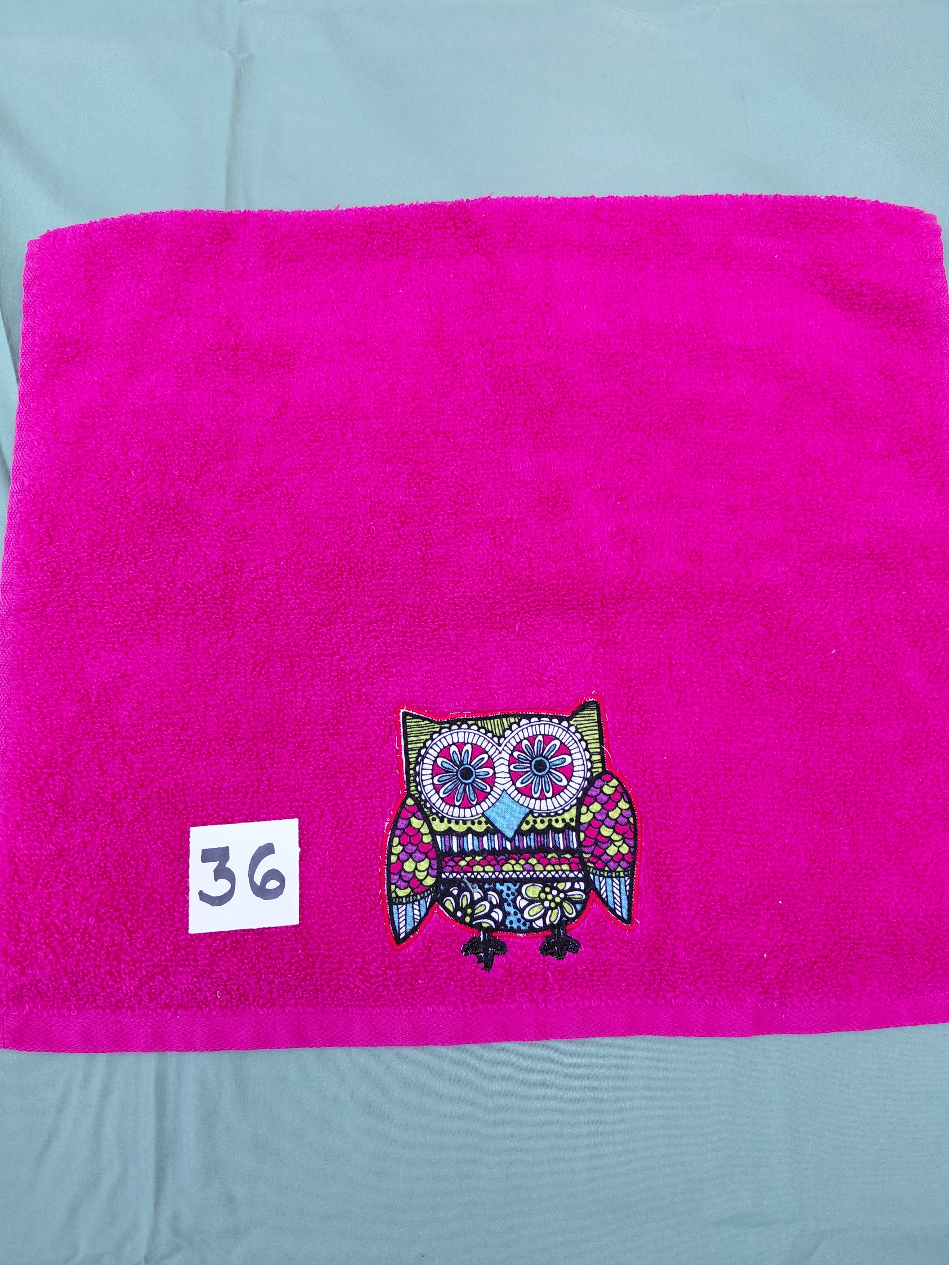 Magenta handcrafted embellished hand towel with bright red outlined owl appliqué, reinforced hem