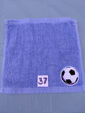 Sky blue handcrafted embellished washcloth with soccer ball appliqué, reinforced hem