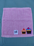 Rose pink handcrafted embellished washcloth with two cupcake appliqués, reinforced hem