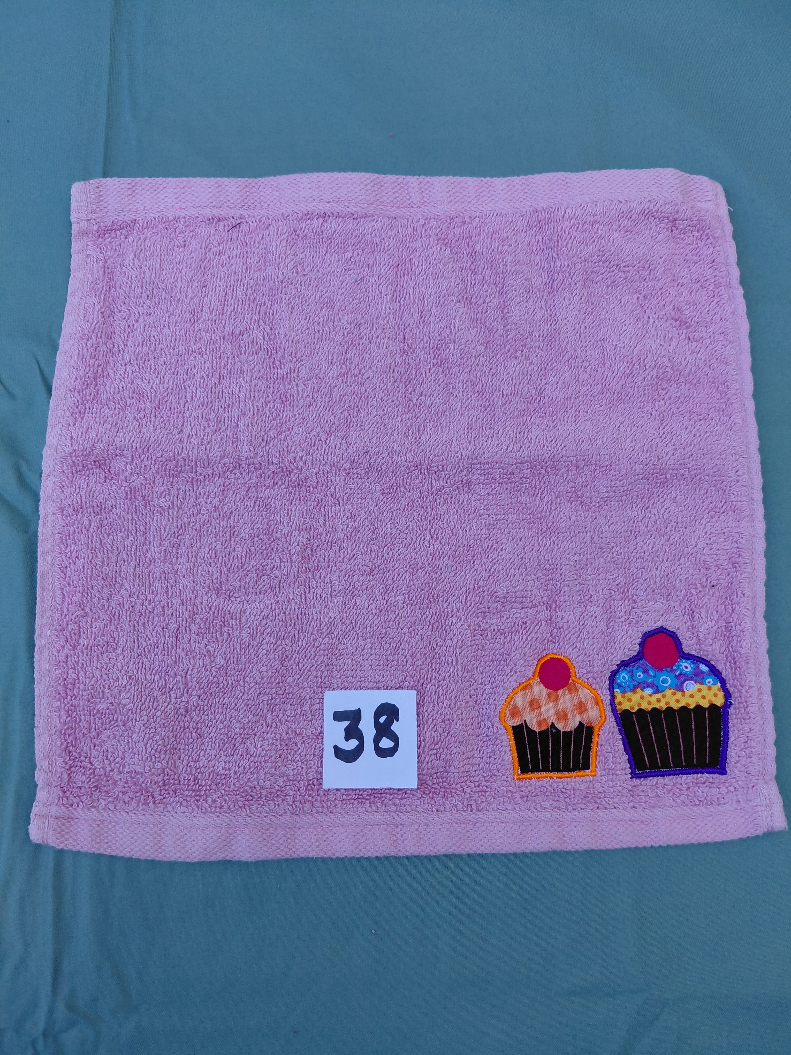 Rose pink handcrafted embellished washcloth with two cupcake appliqués, reinforced hem