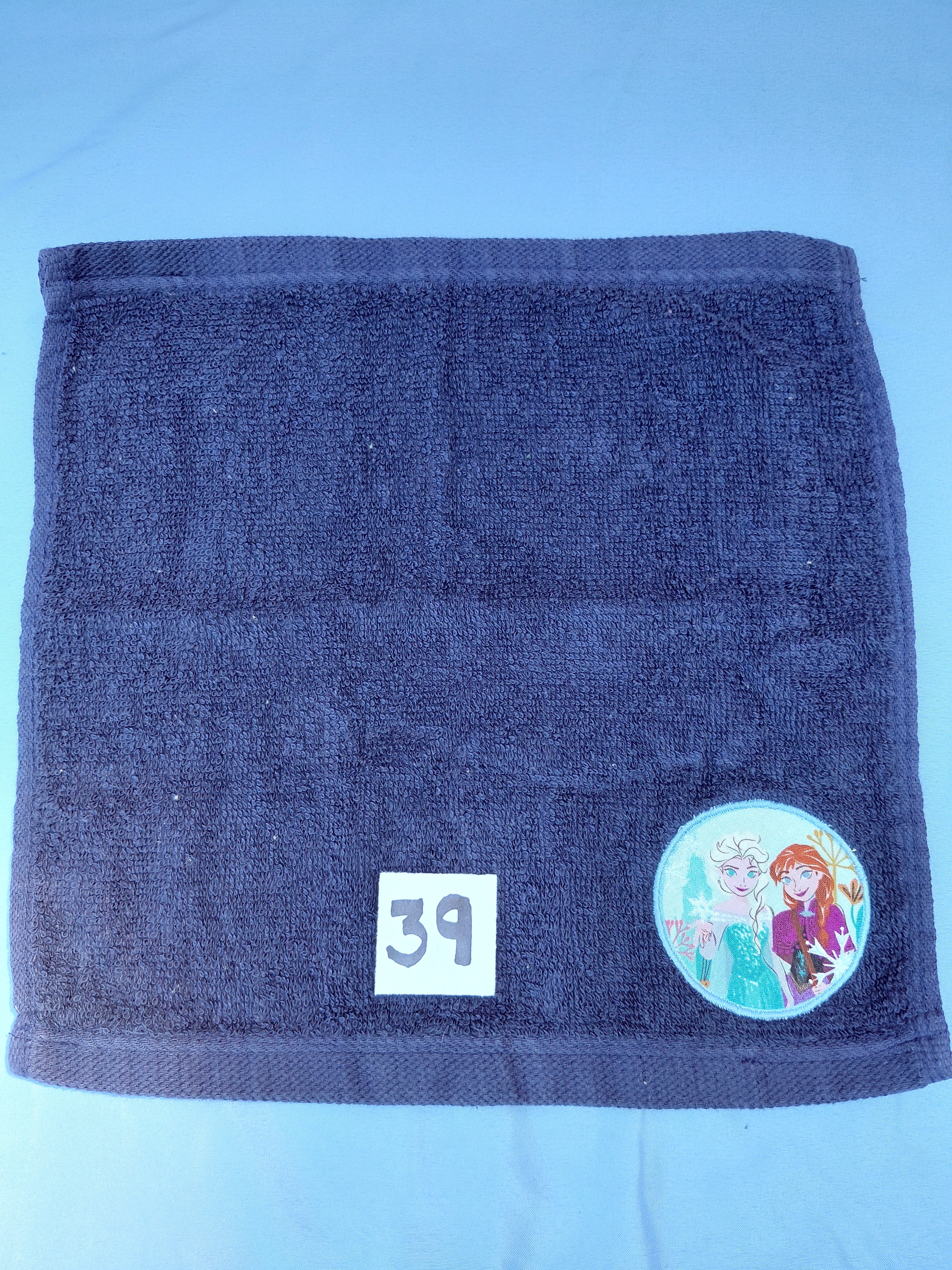 Dark blue handcrafted embellished washcloth with two princesses appliqué, reinforced hem