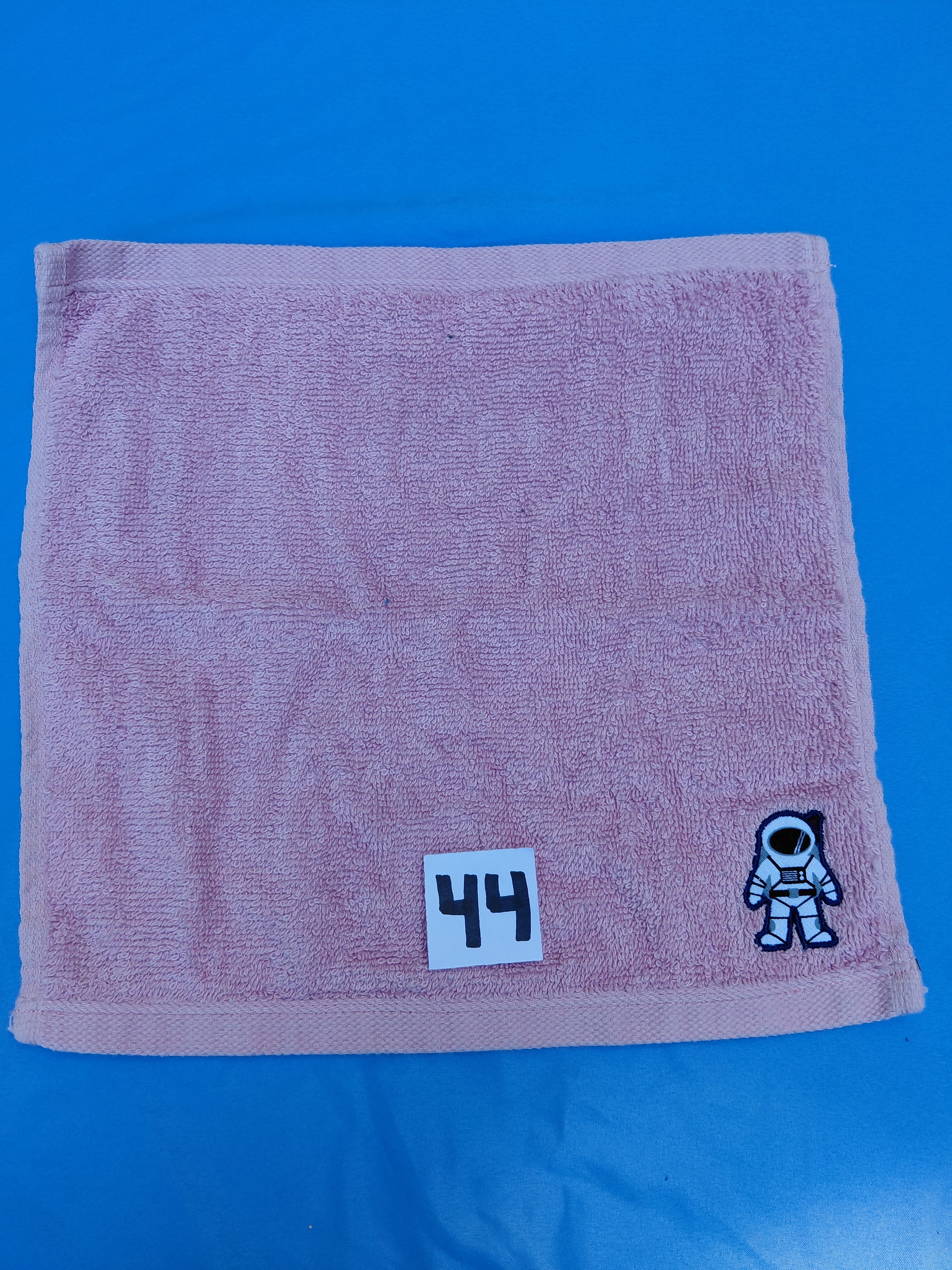 Rose pink handcrafted embellished washcloth with astronaut appliqué, reinforced hem