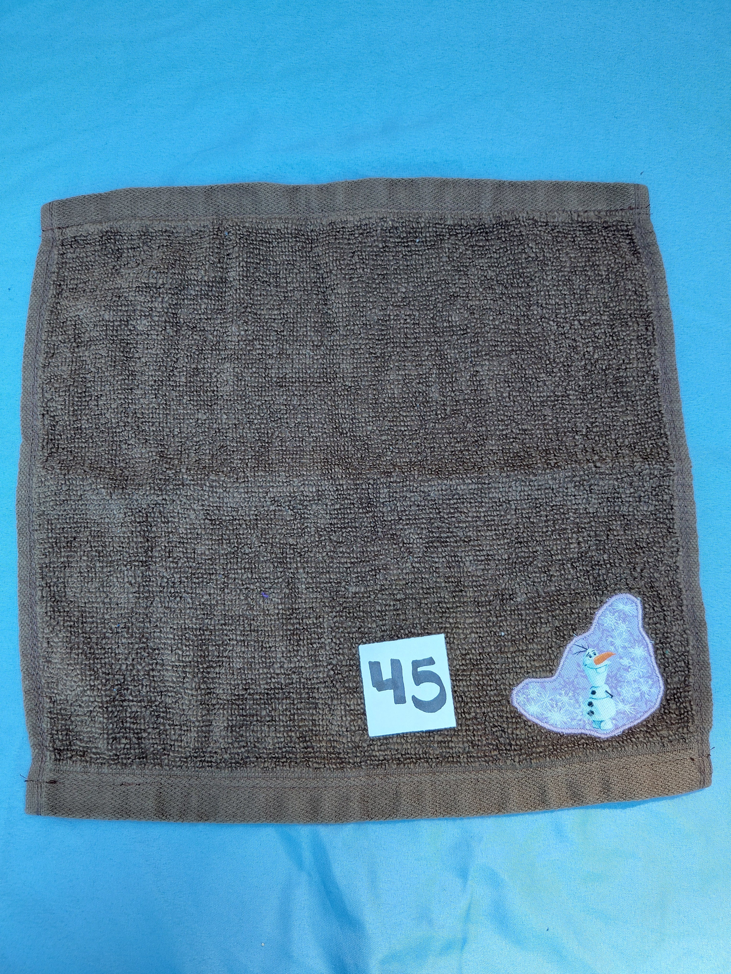 Chocolate brown handcrafted embellished washcloth with snowman appliqué, reinforced hem