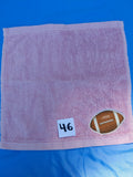 Rose pink handcrafted embellished washcloth with football appliqué, reinforced hem