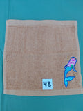 Burnt orange handcrafted embellished washcloth with mermaid appliqué, reinforced hem