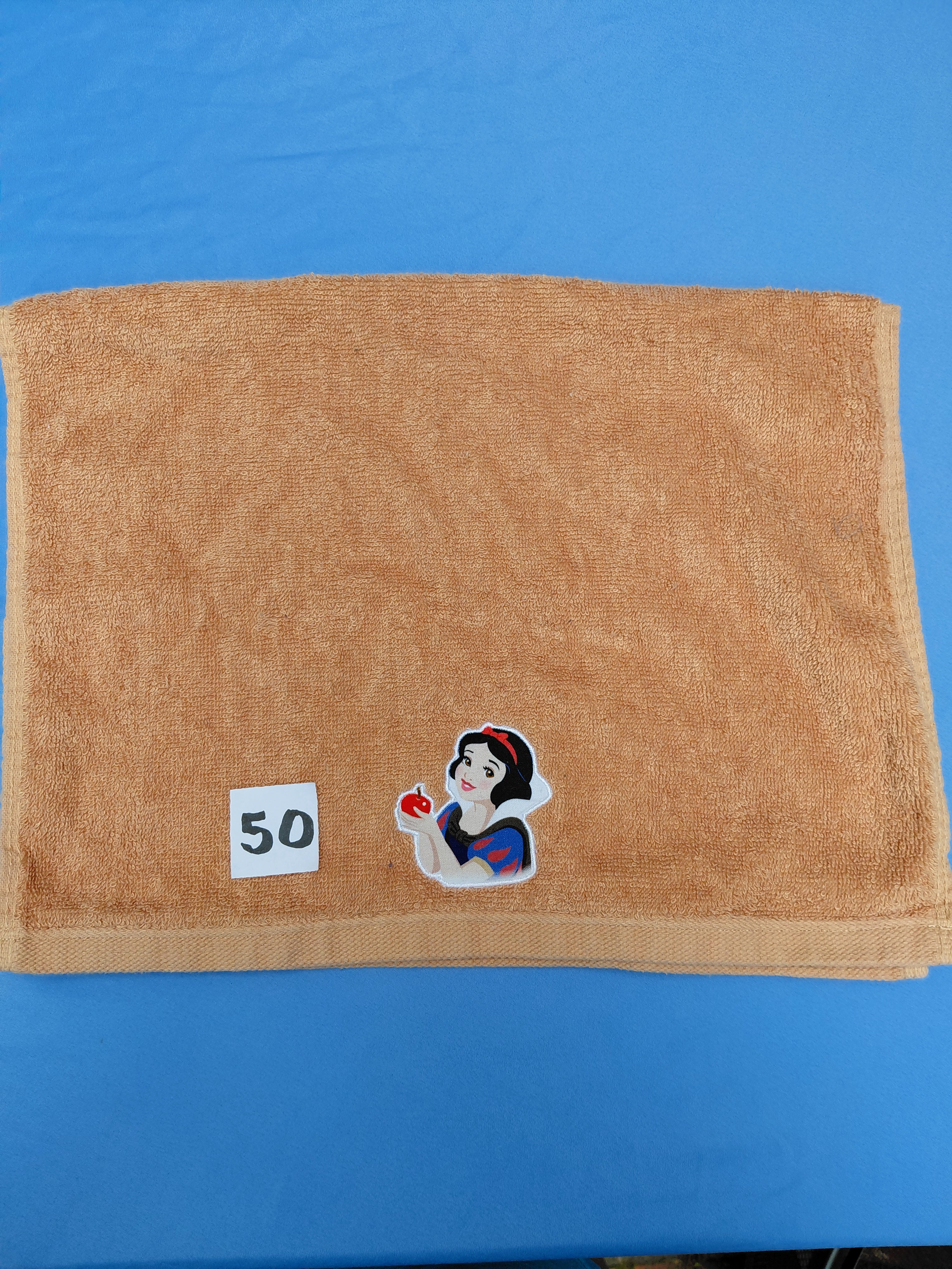 Burnt orange handcrafted embellished hand towel with princess appliqué, reinforced hem