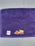 Dark blue handcrafted embellished hand towel with dump truck appliqué, reinforced hem