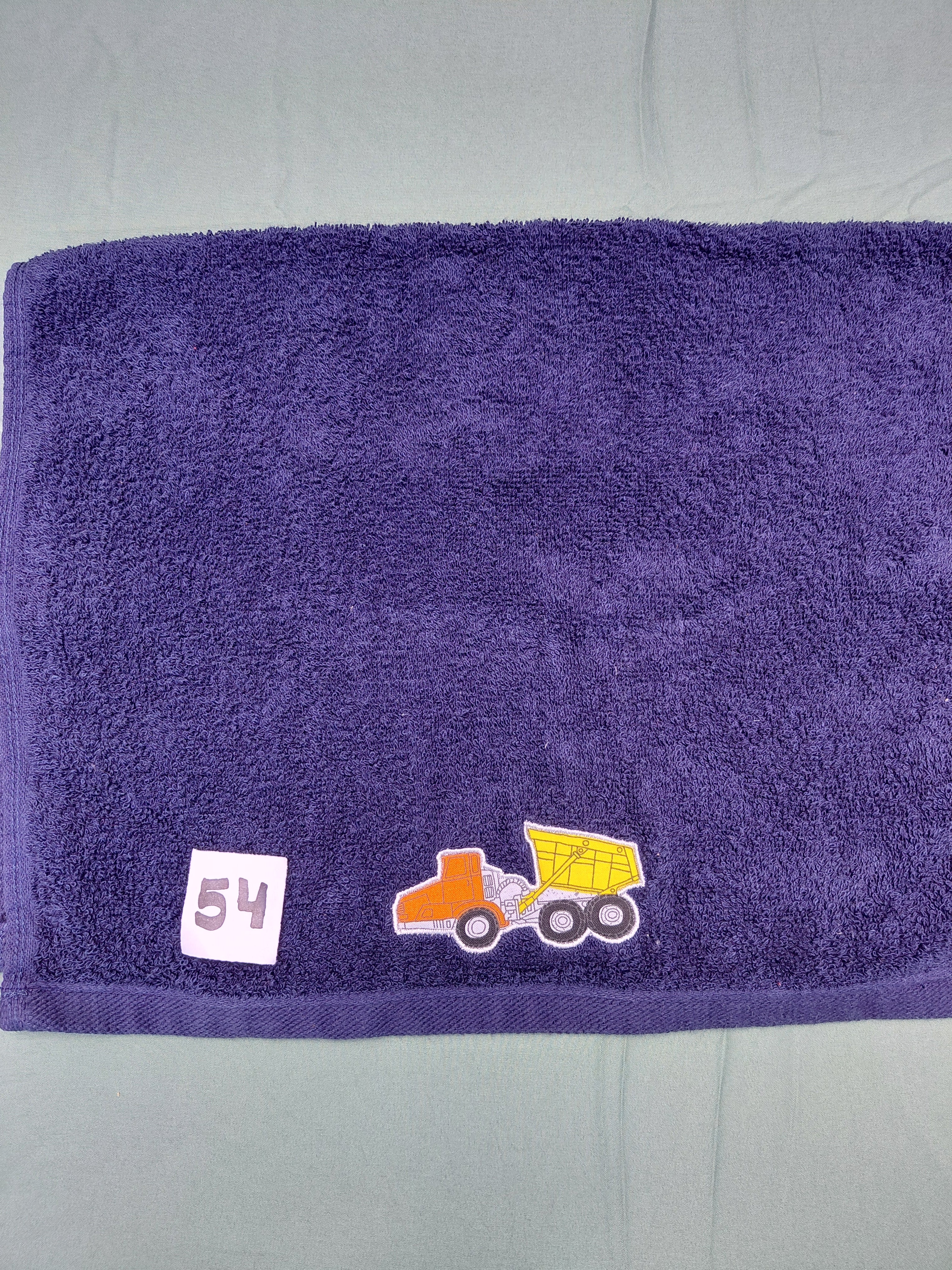 Dark blue handcrafted embellished hand towel with dump truck appliqué, reinforced hem