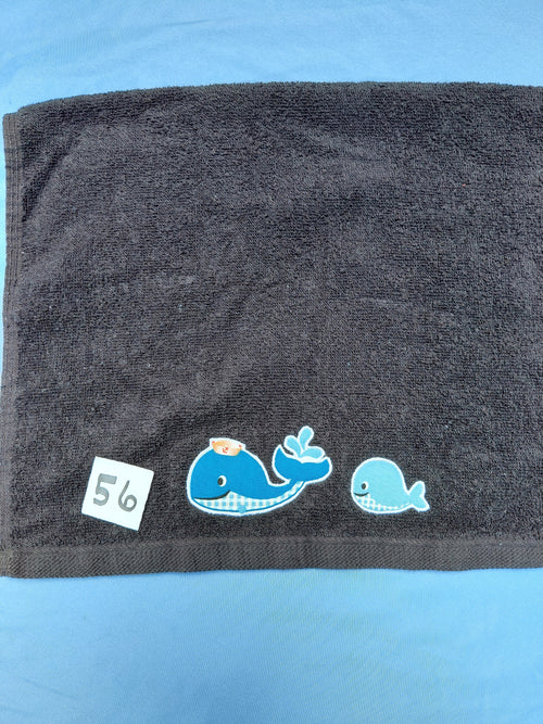 Black handcrafted embellished hand towel with two whales appliqué, reinforced hem