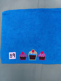 Aqua handcrafted embellished hand towel with three cupcakes appliqué, reinforced hem