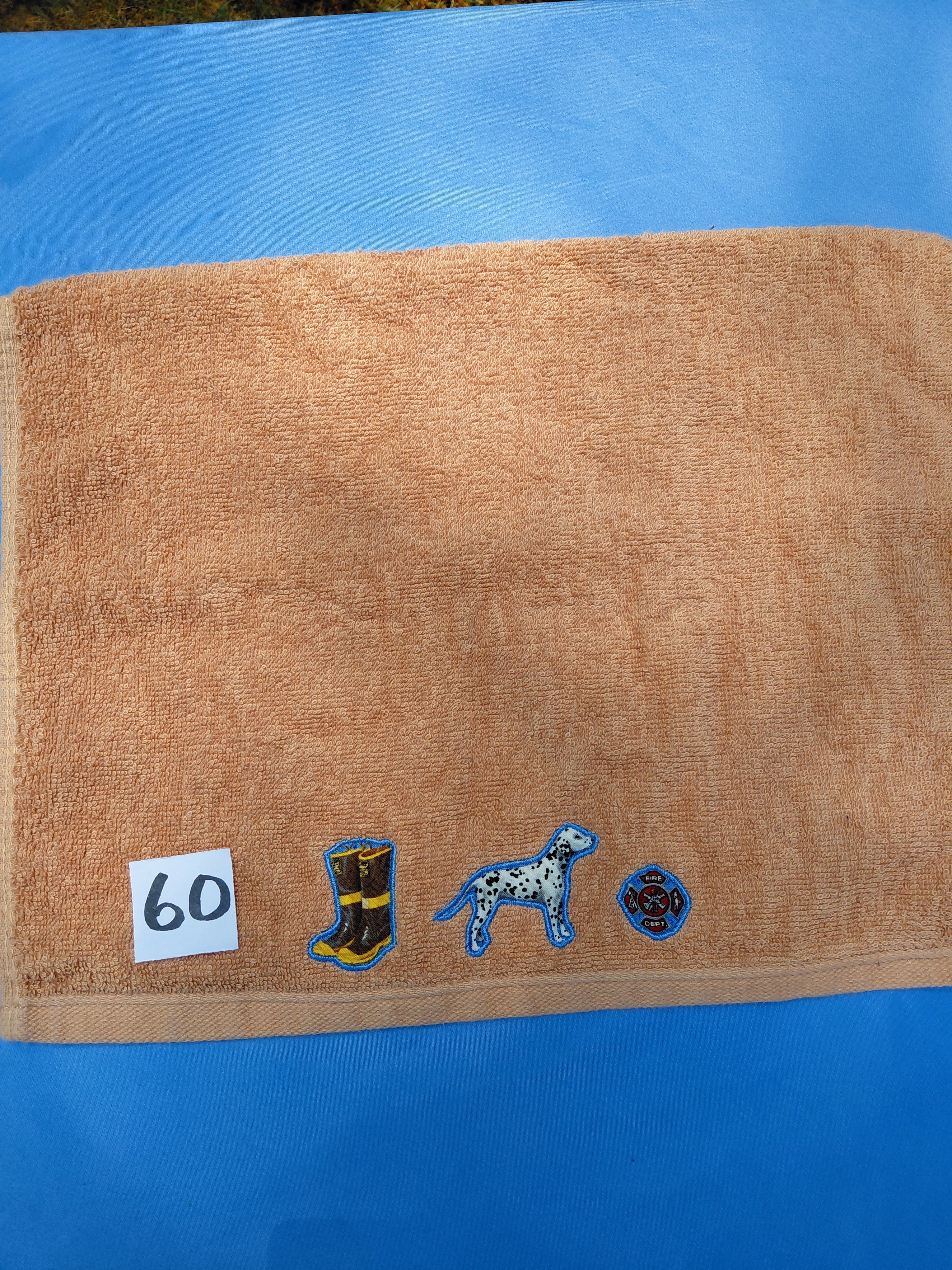 Burnt orange handcrafted embellished hand towel with firefighter boots and dalmatian appliqué, reinforced hem