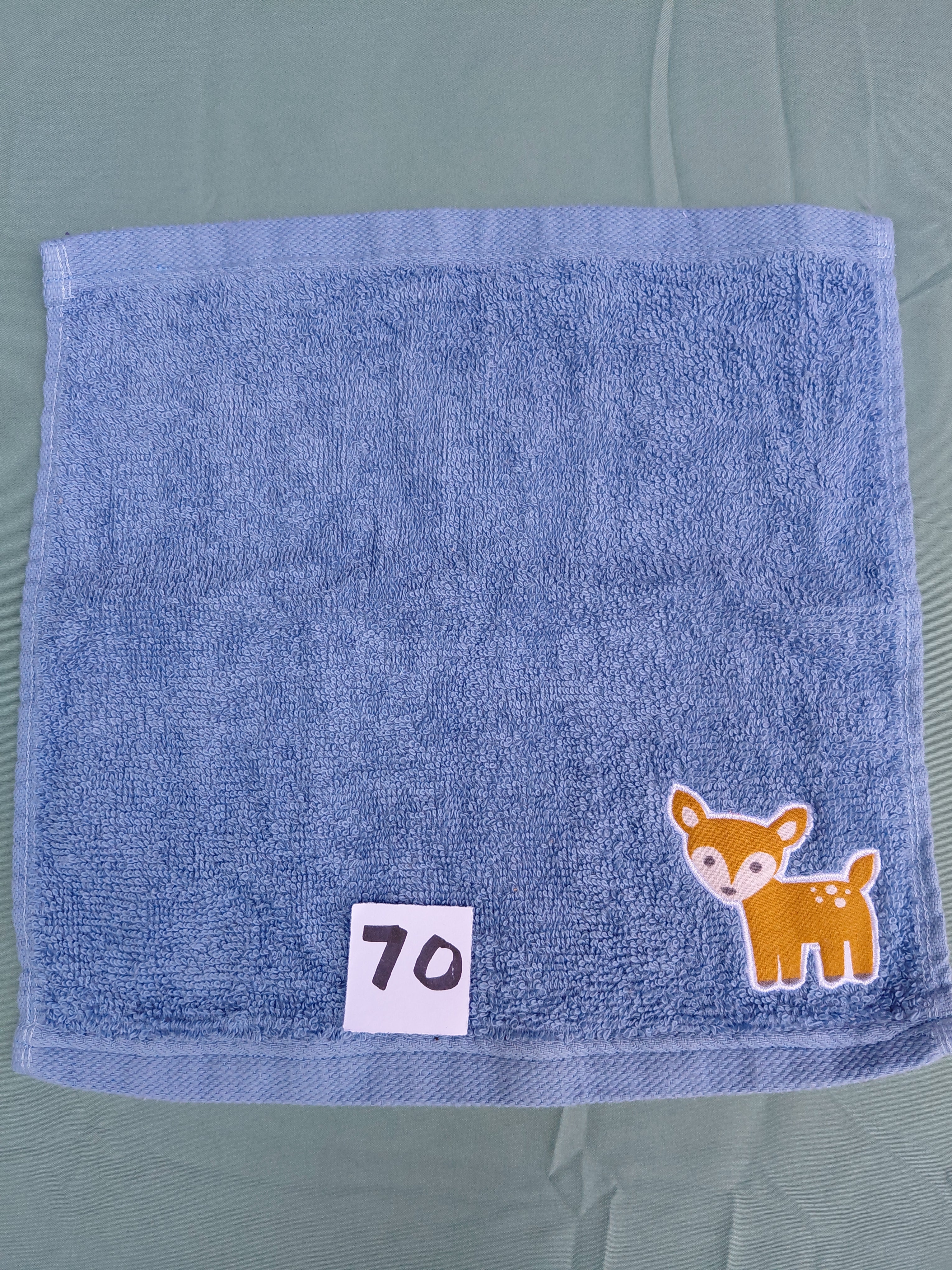 Sky blue handcrafted embellished washcloth with deer appliqué, reinforced hem