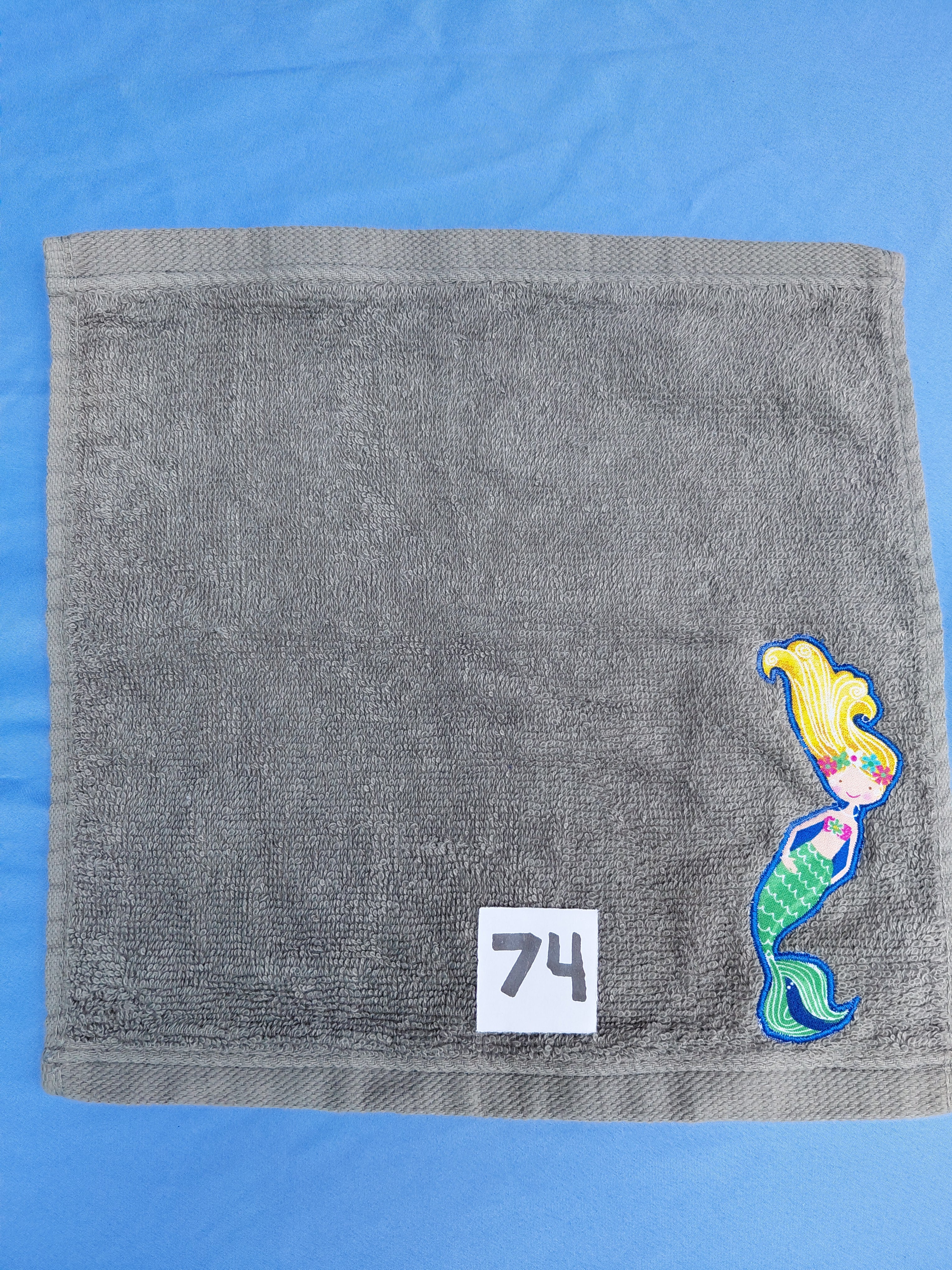 Stormy sky gray handcrafted embellished washcloth with mermaid appliqué, reinforced hem