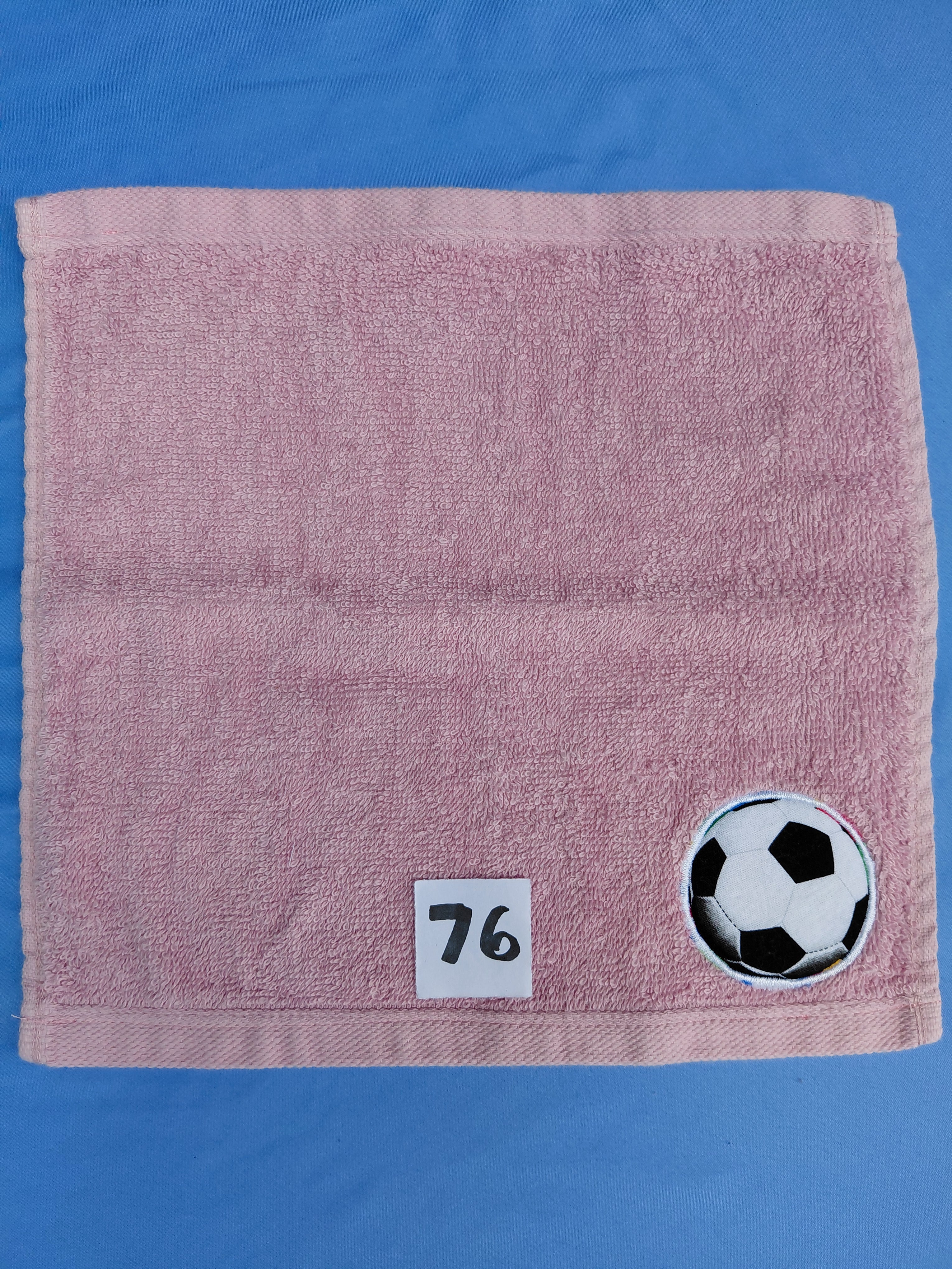 Rose pink handcrafted embellished washcloth with soccer ball appliqué, reinforced hem