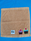 Burnt orange handcrafted embellished washcloth with cupcakes appliqué, reinforced hem