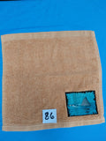 Burnt orange handcrafted embellished washcloth with shark fin appliqué, reinforced hem